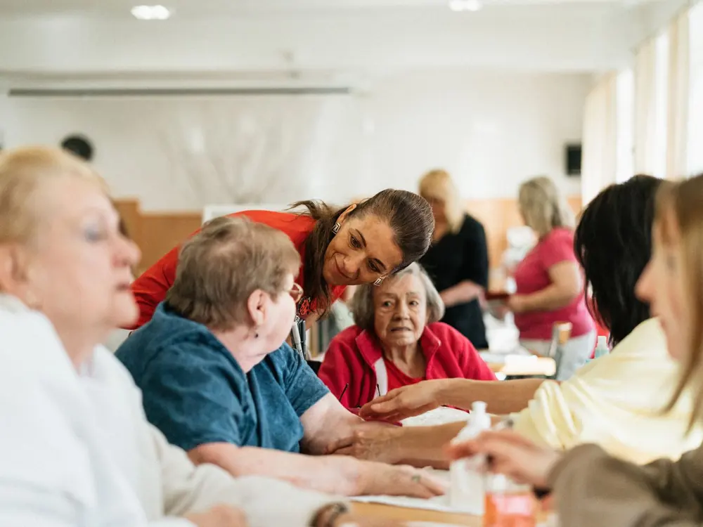 Senior residents participating in a community activity with a staff member